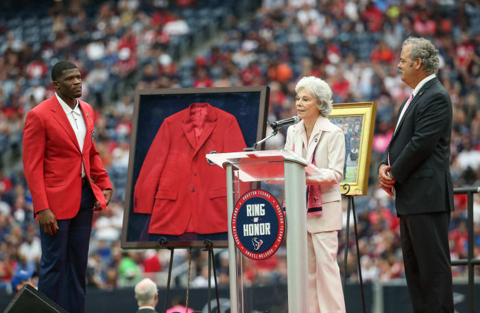 Texans former player Andre Johnson, chairman and chief operating officer D. Cal McNair look on as senior chair Janice McNair (middle) addresses the crowd at NRG Stadium.